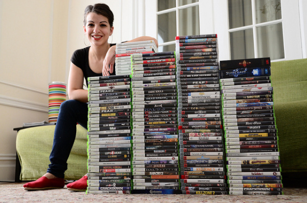 Sneaky Anita Sarekeesian, trying to hide behind a stack of video games.